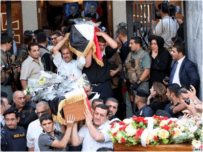 Description: Christians carry coffins of their slain relatives during a funeral service at a church in Baghdad on November 2 for victims of the attack at the Assyrian Catholic Church of Our Lady of Salvation on the evening of October 31.